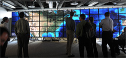 Photo of visitors from National Geographic Society get a first look at a NASA Blue Marble visualization of Earth on the 70-tile HIPerSpace wall at Calit2 on the UC San Diego campus.