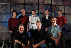 Photo of some members of the GRAVITY lab at Calit2 in front of the HIPerSpace wall.