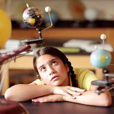 Photo of girl looking at spinning globe