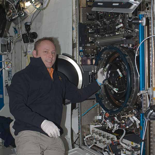Astronaut Mike Fincke pictured to the left of the Combustion Integrated Rack facility installed in the Destiny module of the ISS shortly after installation. Photo: NASA