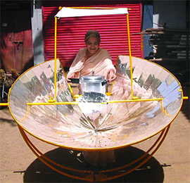 Photo of Indian women and solar cooker