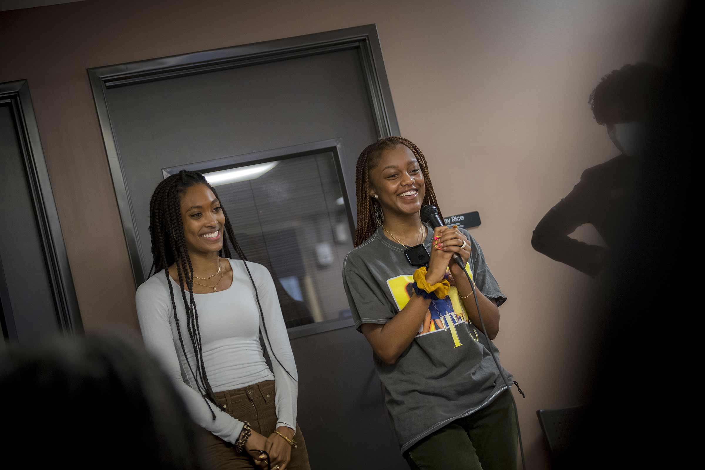 Students Kennedy Cofield and Jaida Day welcome guests to the Black Resource Center for the Black Family Get Together event.