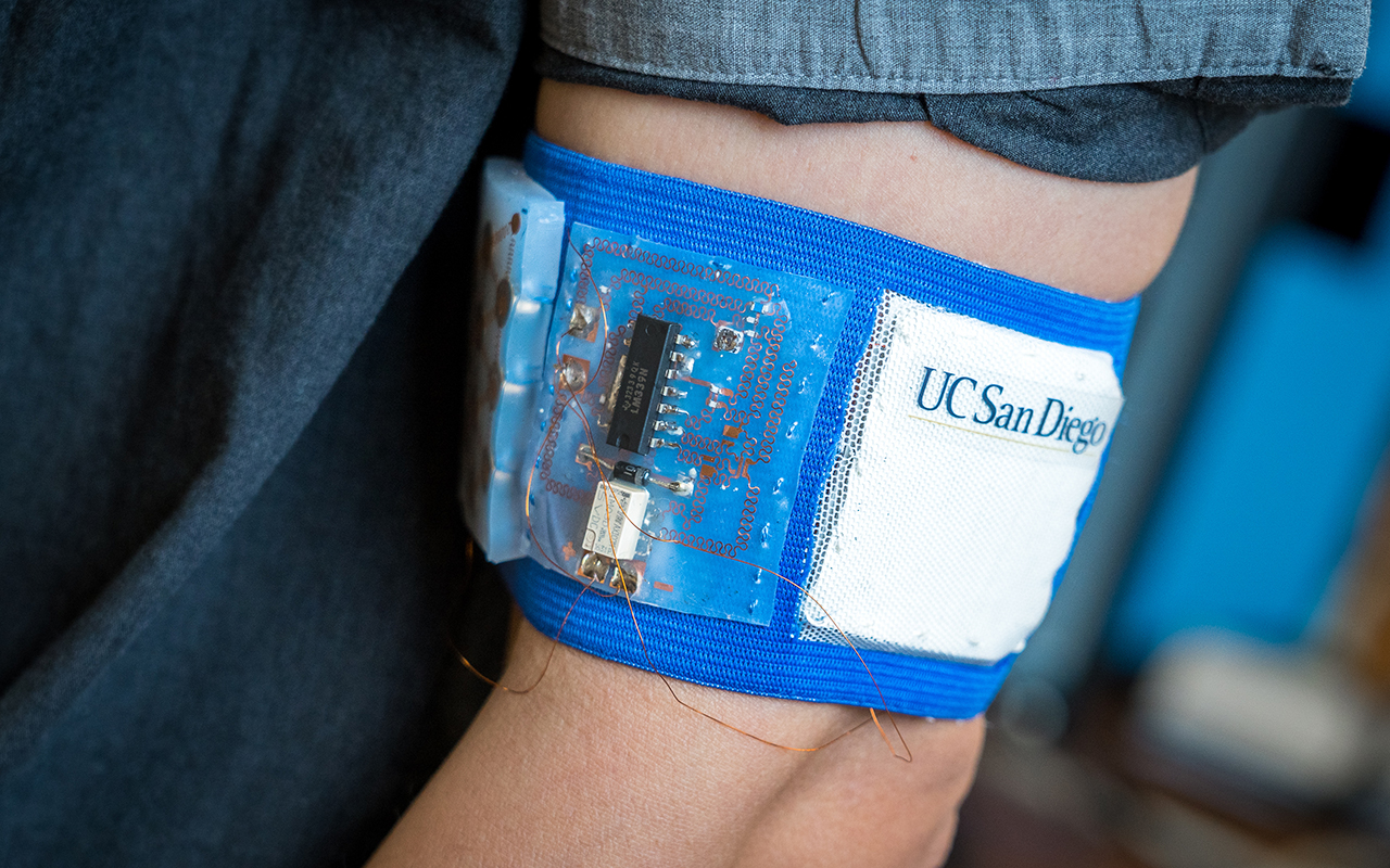 Prototype of the cooling and heating patch embedded in a mesh armband. Photos by David Baillot/UC San Diego Jacobs School of Engineering