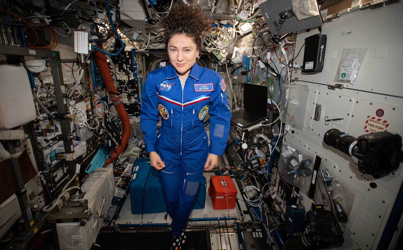 Jessica Meir poses for a portrait in the weightless environment of the International Space Station.