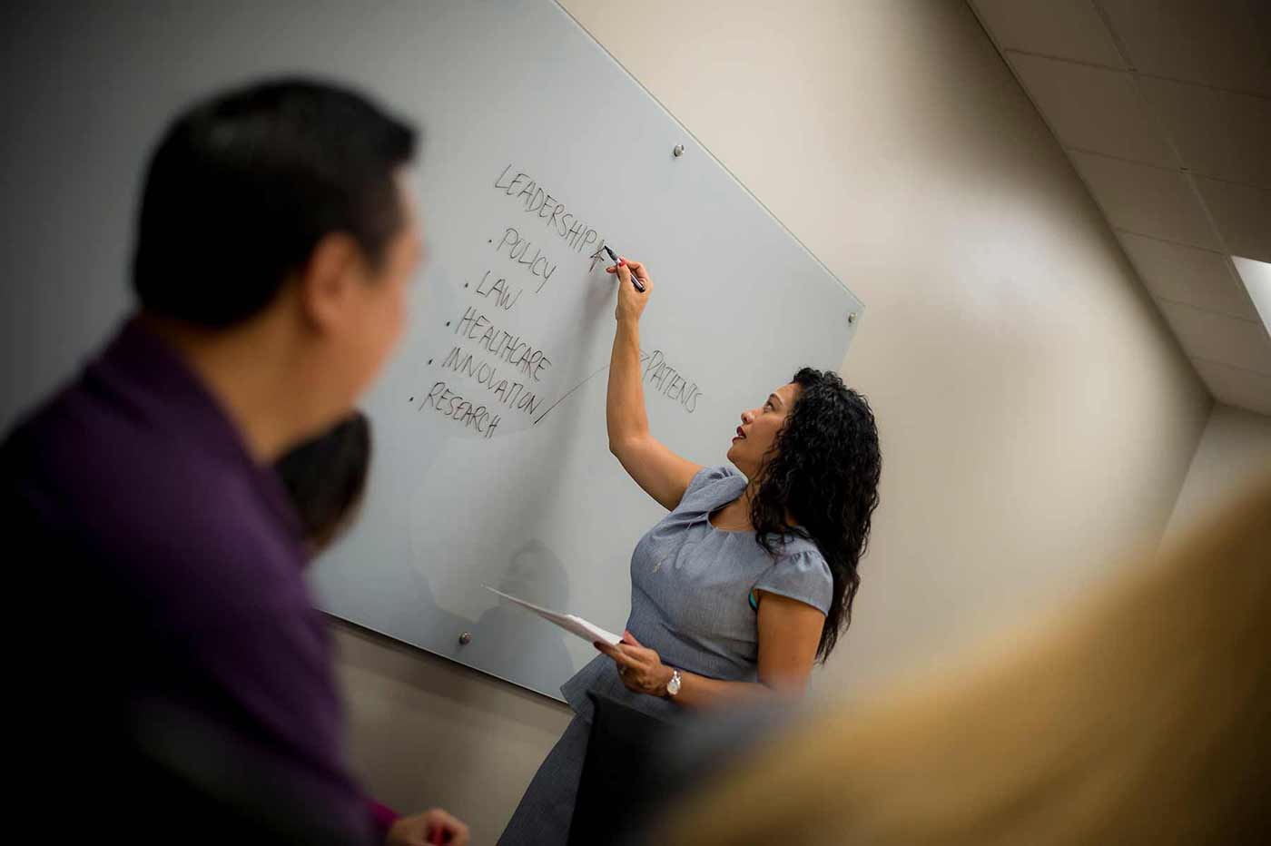 Professor writing on a board