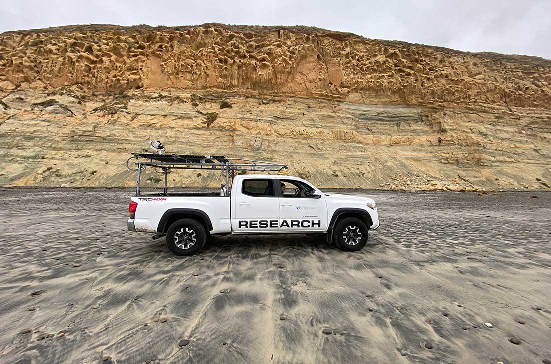 Adam Young and Lucian Perry conduct a truck-based LiDAR scan of the cliffs at Torrey Pines State Beach.