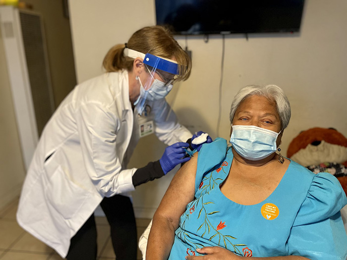 Brenda Tanoi receives her second does of Moderna vaccine.