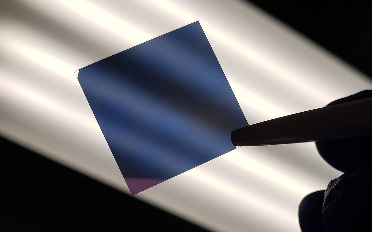 Square, semi-transparent material held against light.