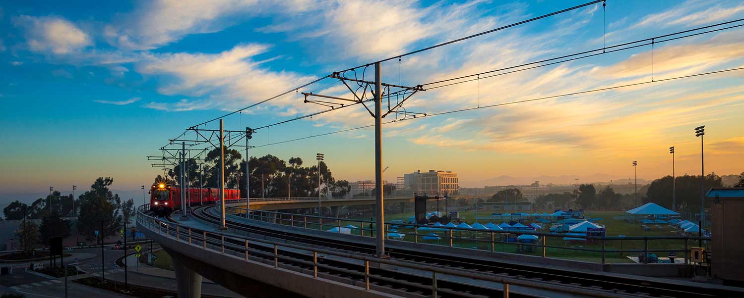 Blue Line trolley glides around UC San Diego’s Warren Field.