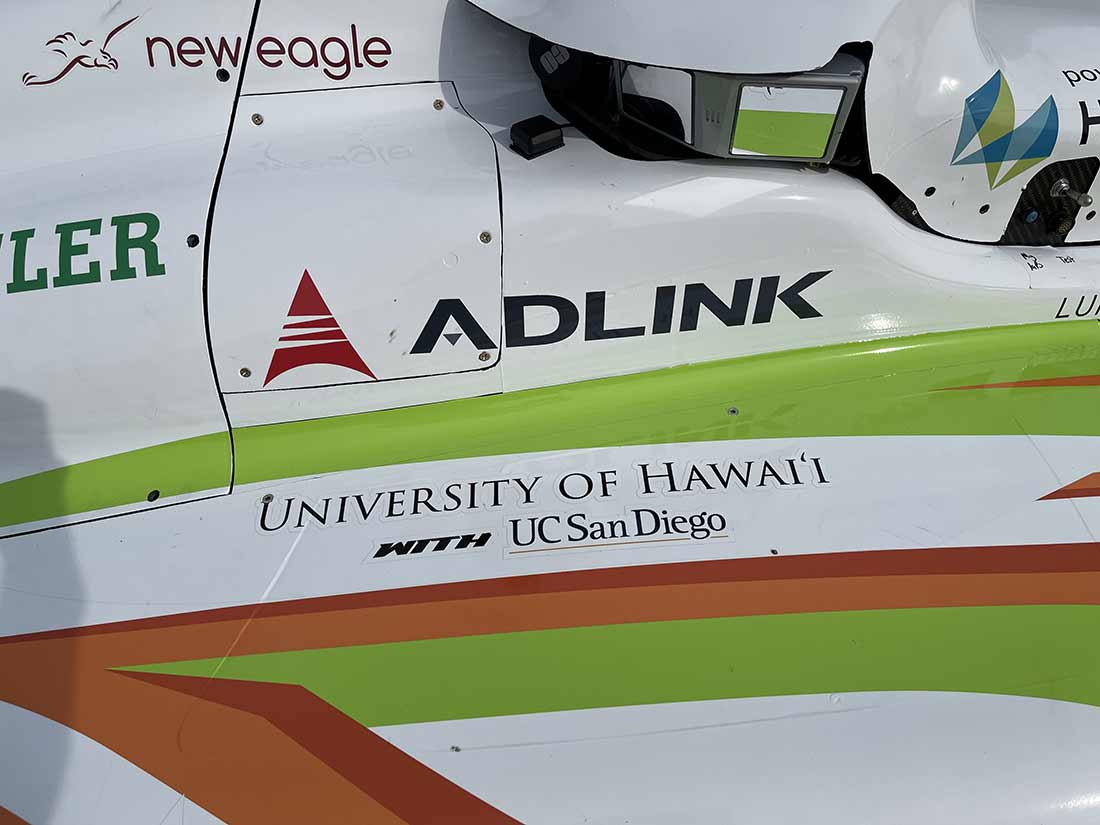 UC San Diego and partner University of Hawai'i logos on an autonomous car.