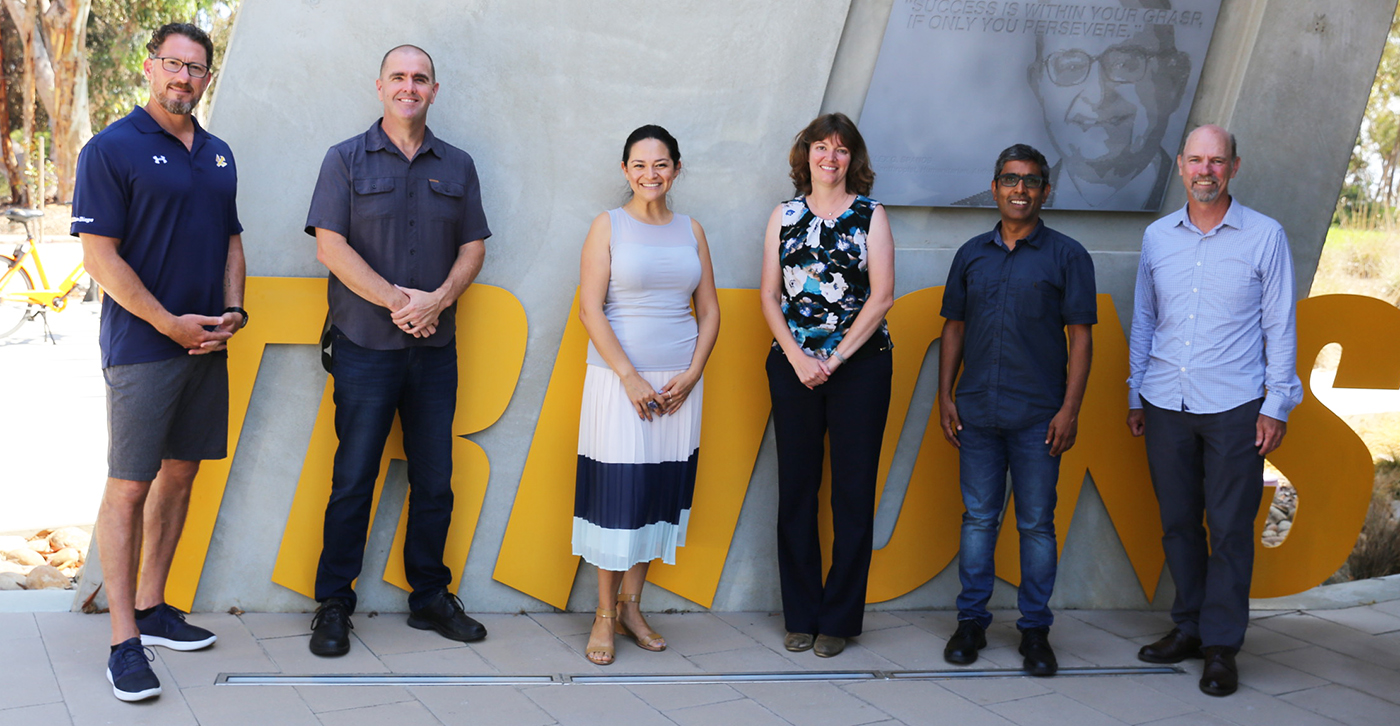 Six UC San Diego and Salk Institute researchers stand next to one another outside 